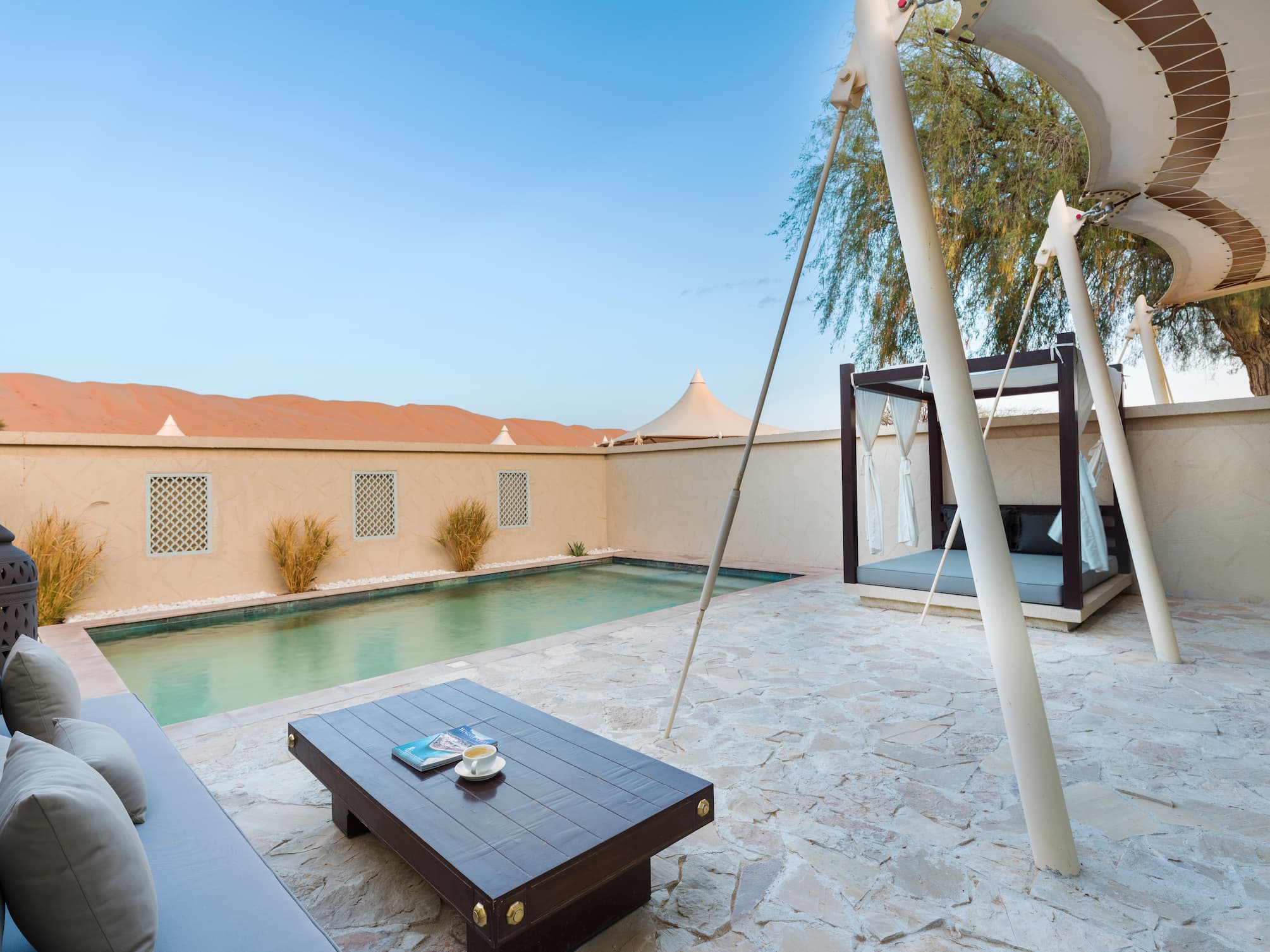 Private terrace of a Pool Villa at Desert Nights Resort Oman overlooking the Wahiba Sands and offering outdoor space for relaxation