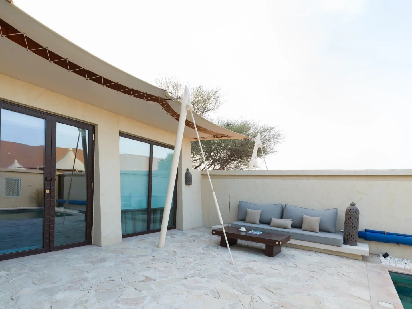 Outdoor area of a Pool Villa at Desert Nights Resort Oman featuring private relaxation space surrounded by the dunes of the Wahiba Sands desert