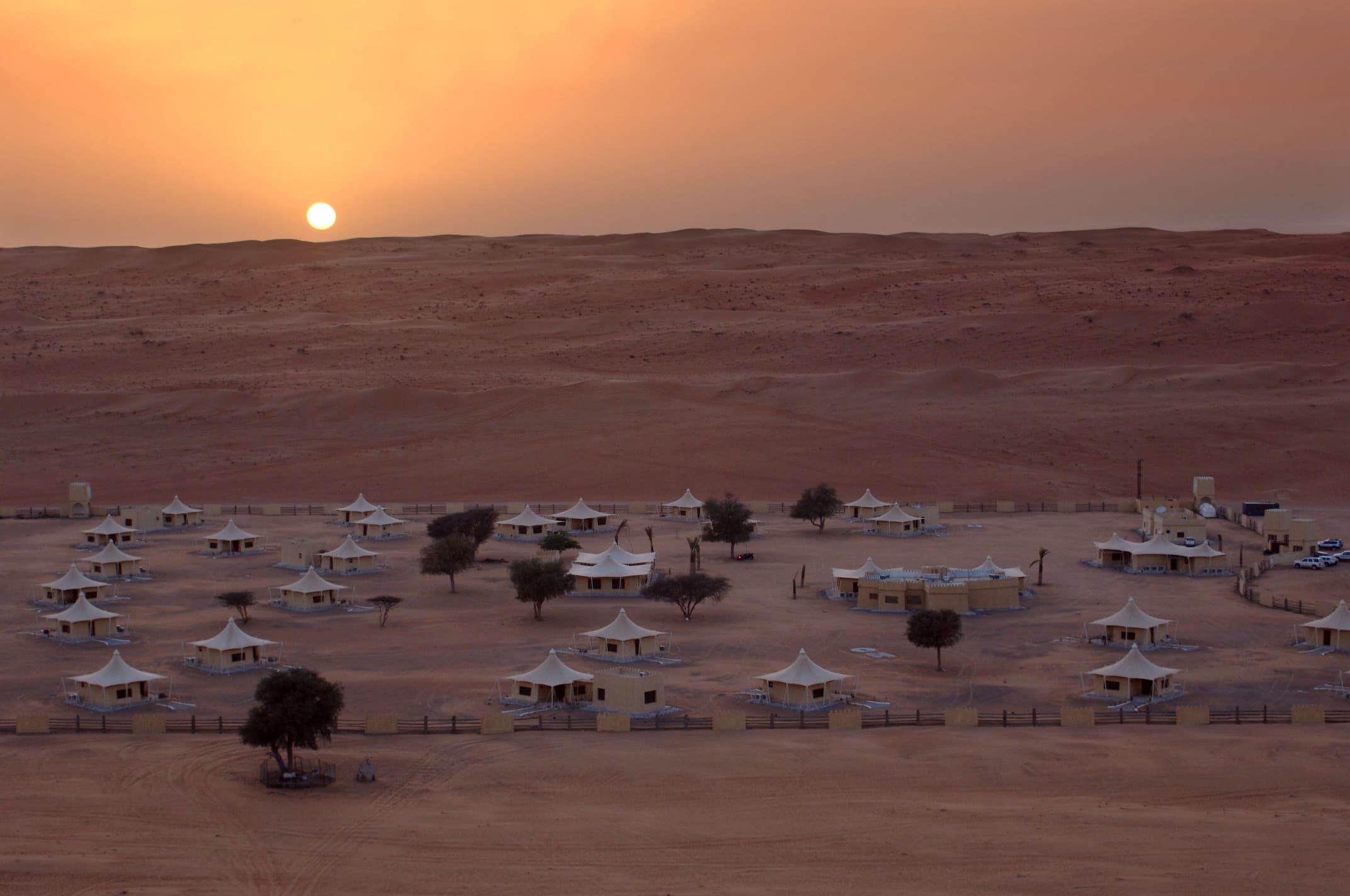 Sunrise and sunset views over the golden dunes of Wahiba Sands at Desert Nights Resort Oman